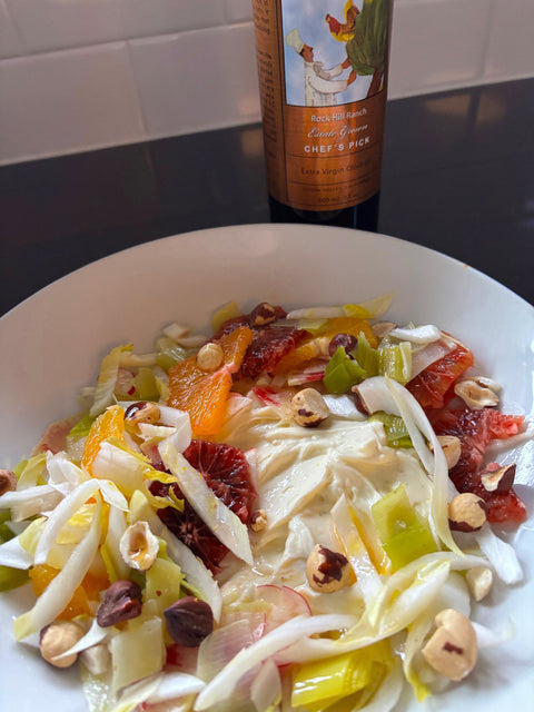 A close up of a  plate of KATZ Citrus Salad with sliced fennel, sliced endive, sliced red and orange citruses, red radishes and chopped hazelnuts