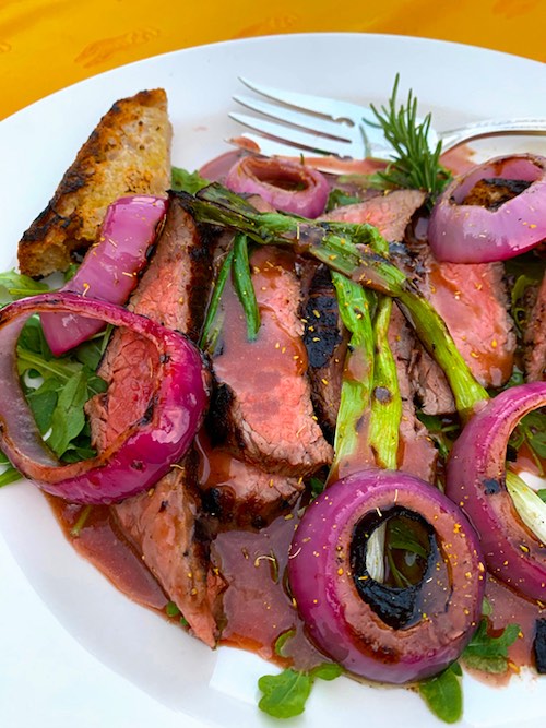 KATZ Zinfandel Vinegar, Honey & Worcestershire Sauce drizzled over a plate of steak and grilled vegetables